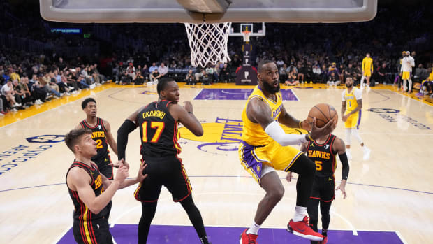 Mar 18, 2024; Los Angeles, California, USA; Los Angeles Lakers forward LeBron James (23) shoots the ball against Atlanta Hawks forward Onyeka Okongwu (17) in the second half at Crypto.com Arena. Mandatory Credit: Kirby Lee-USA TODAY Sports